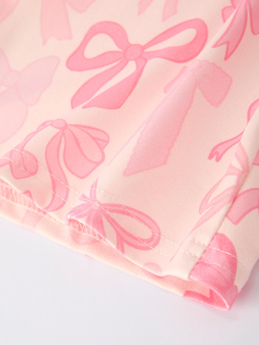 Brielle - Girl's Pink Bow Print Long Sleeve Jumpsuit